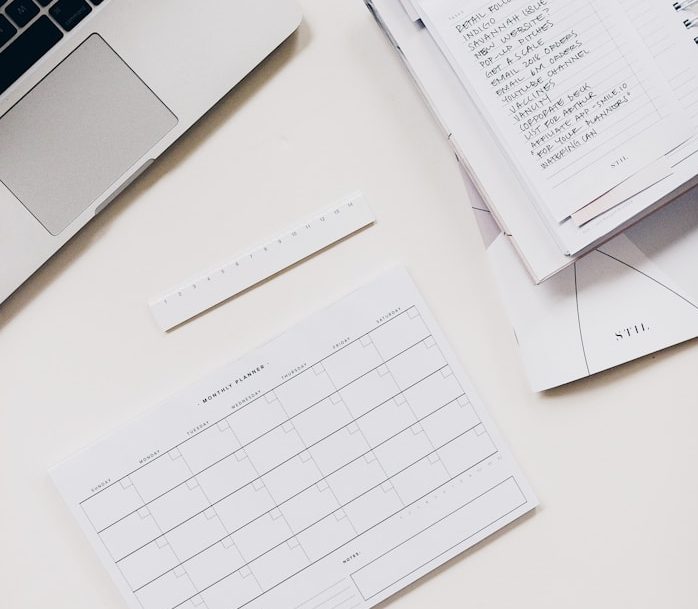Photo of a desk showing laptop and diary