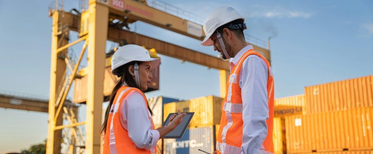 Two people in PPE on an industrial site